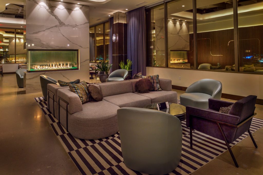 360 westport sitting area with couch. chairs and fireplace